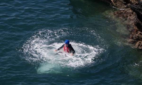 man in water coast steering