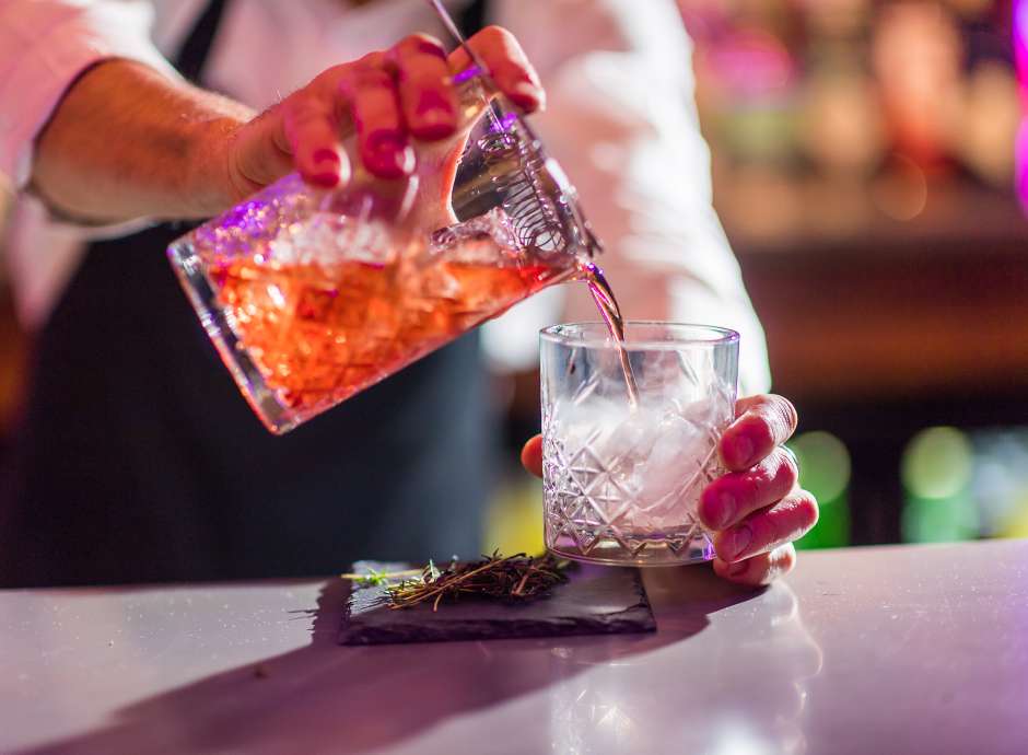 man poring a cocktail in Bar 62