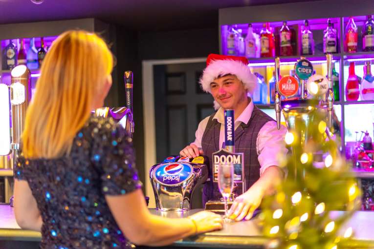 Lady being served in Merchants Bistro Bar