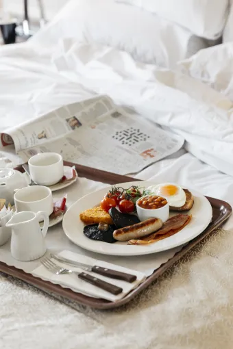 A tray with a cooked breakfast on one of the beds in The Royal Hotel Bideford
