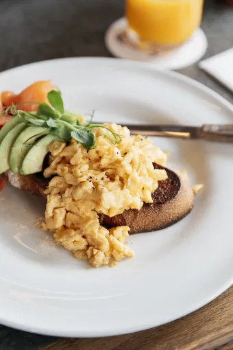 A close up shot of a plate of scrambled eggs on toast with avocado at The Royal Hotel Bideford