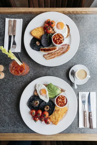 A top down view of two cooked breakfasts set on a table in The Royal Hotel Bideford