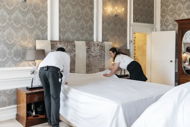 Members of the team at The Royal Hotel Bideford making a bed in one of the guest bedrooms