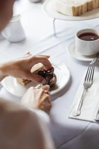 A guest cutting into one of the cakes available on the Afternoon Tea at The Royal Hotel Bideford