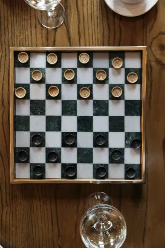 A top down view of a Draughts board and wine glasses inside The Royal Hotel Bideford