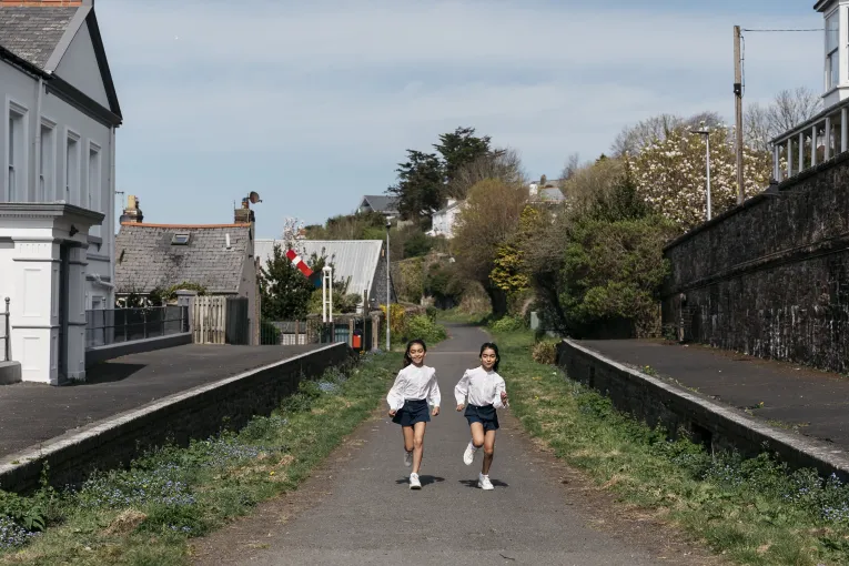 Two girls running along the Tarka Trail outside of The Royal Hotel Bideford