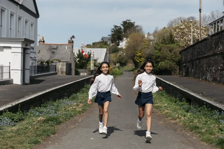 Two girls running along the Tarka Trail just outside the Royal Hotel Bideford