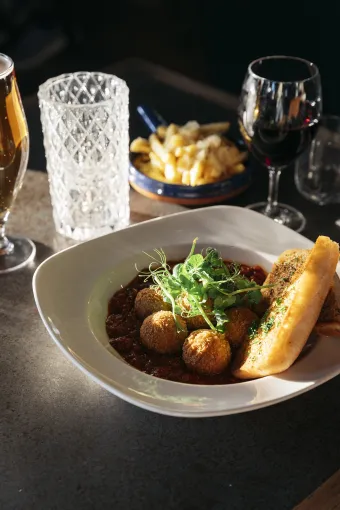An arancini dish on a table with drinks at The Royal Hotel Bideford