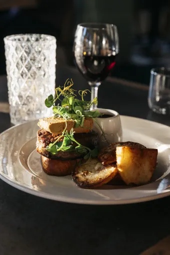 A plate of food with drinks glasses in the background at The Royal Hotel Bideford