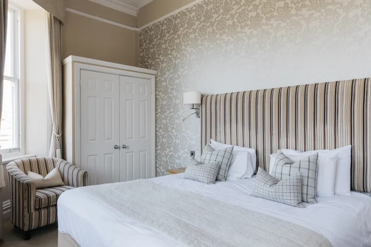 A King-size bed and wardrobe in one of the bedrooms at The Royal Hotel Bideford