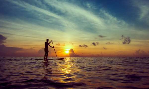 Man on SUP board in sunset