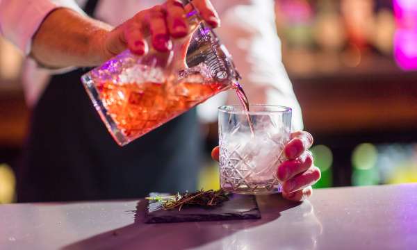man poring a cocktail in Bar 62