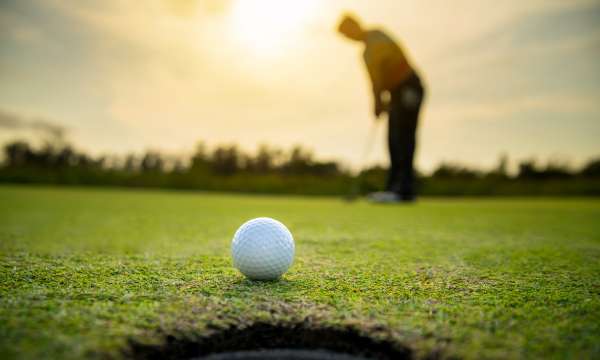 golf ball and person on golf course