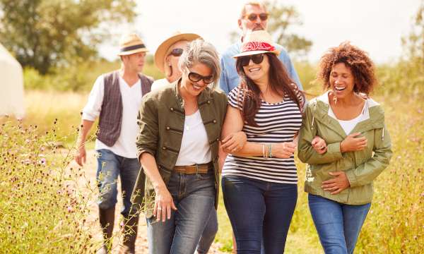 group of friends walking in meadow