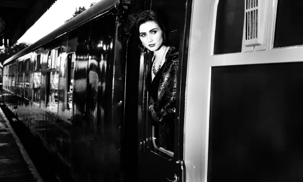 Woman boarding vintage train
