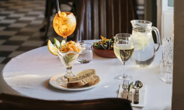 A prawn cocktail on a table in The Royal Hotel Bideford with a cocktail and a glass of wine
