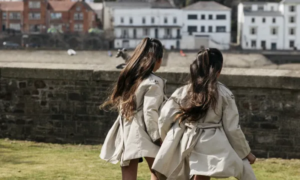 Two girls running on the grass in the garden area outside The Royal Hotel Bideford
