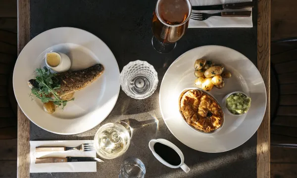 A top down view of a fish dish and a pie dish on a table in The Royal Hotel Bideford