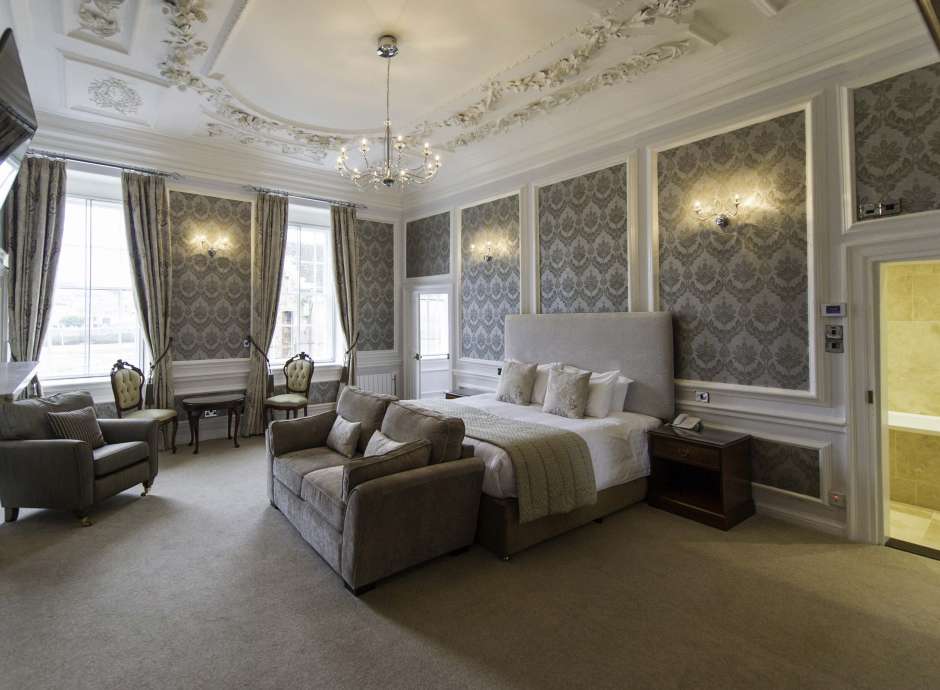 Royal Hotel Accommodation Bedroom with Lounge Area and Fireplace