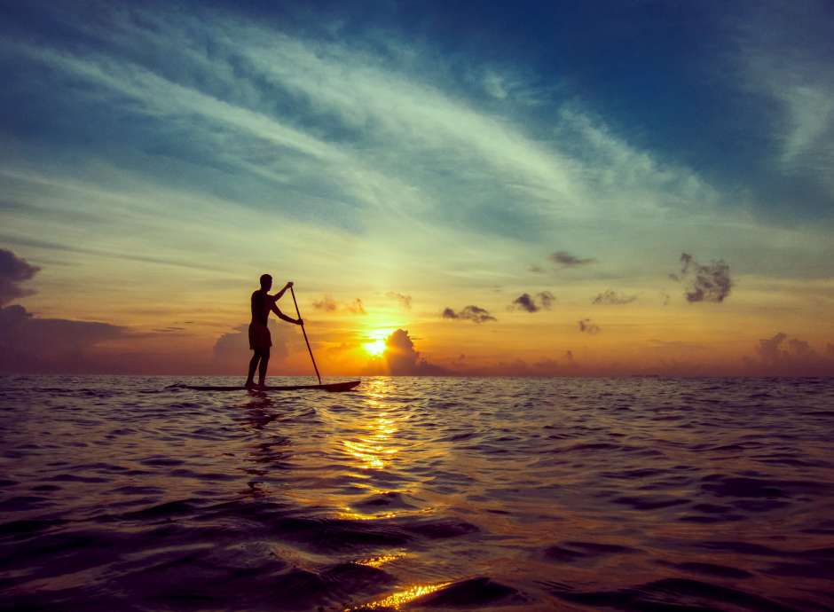 Man on SUP board in sunset