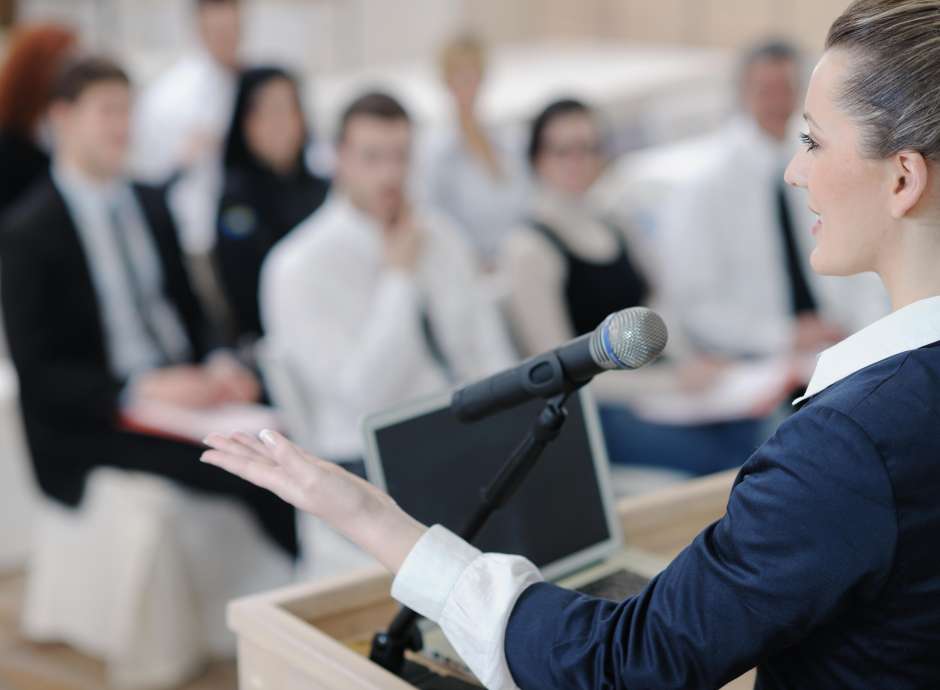 Business woman giving a speech at a conference