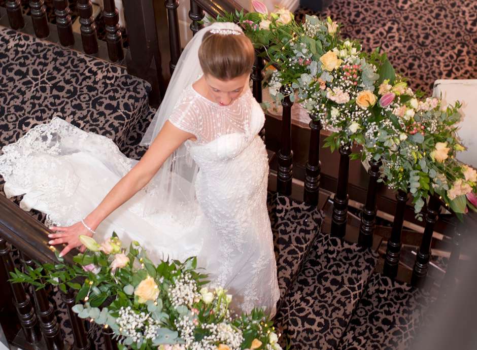 Bride at staircase of Royal Hotel