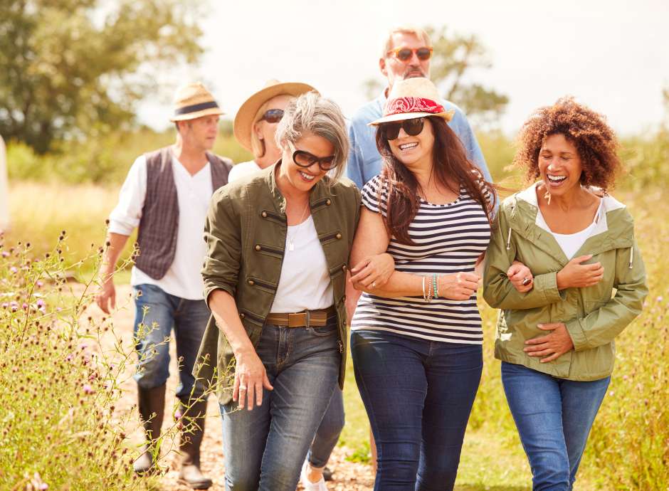 group of friends walking in meadow