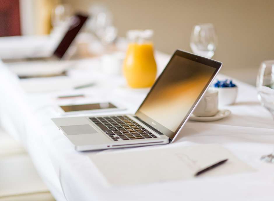 laptop on desk set for meeting