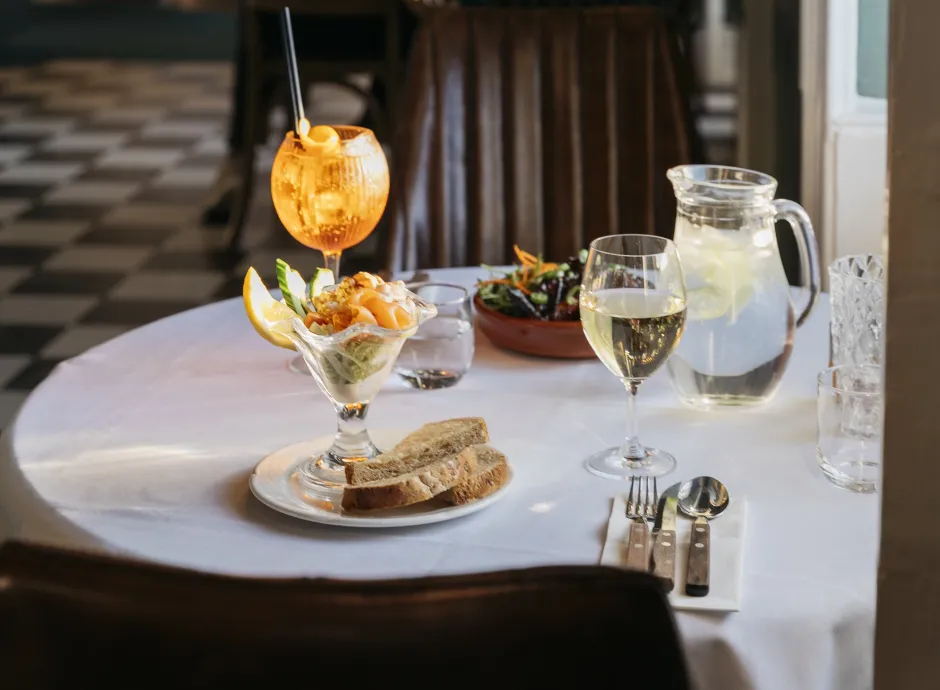 A prawn cocktail on a table in The Royal Hotel Bideford with a cocktail and a glass of wine