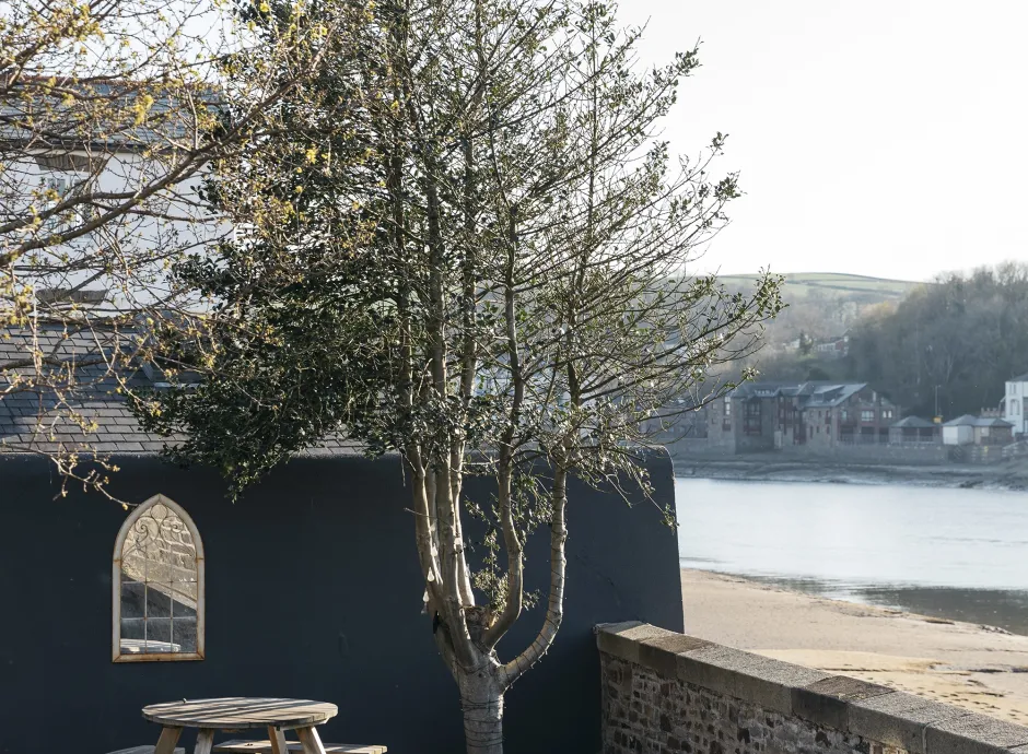 An outdoor walled garden space with a picnic table overlooking the River outside The Royal Hotel Bideford