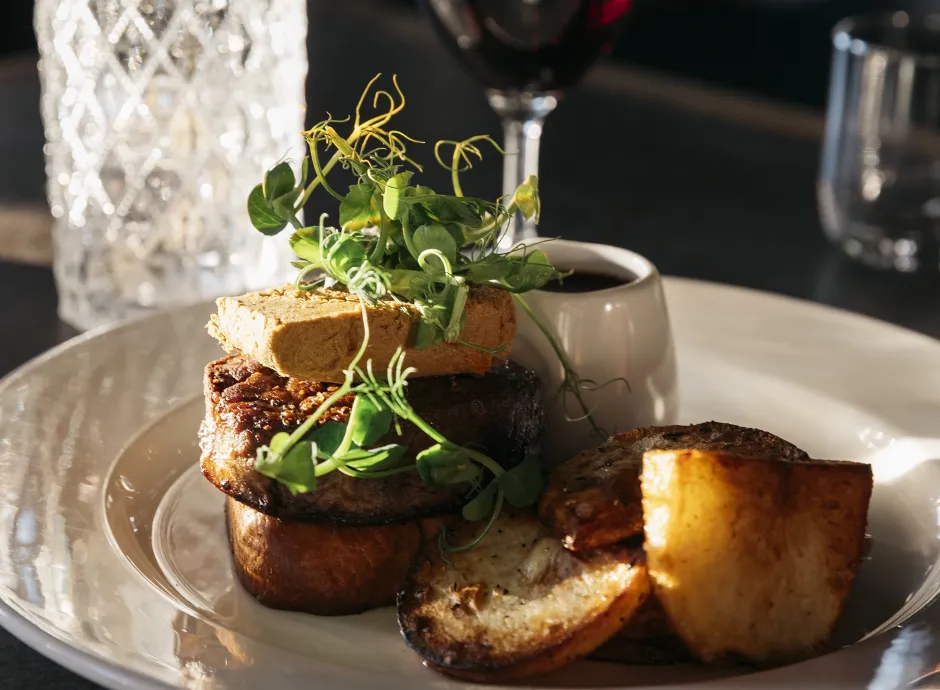 A plate of food with drinks glasses in the background at The Royal Hotel Bideford