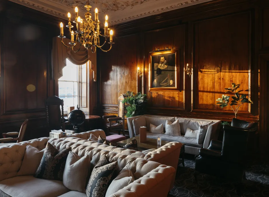 Sofas, chairs and tables in the wood-panelled Kingsley Lounge inside The Royal Hotel Bideford