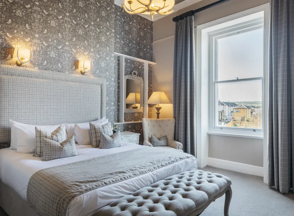 A King-size guest bedroom inside The Royal Hotel Bideford with a view over the town