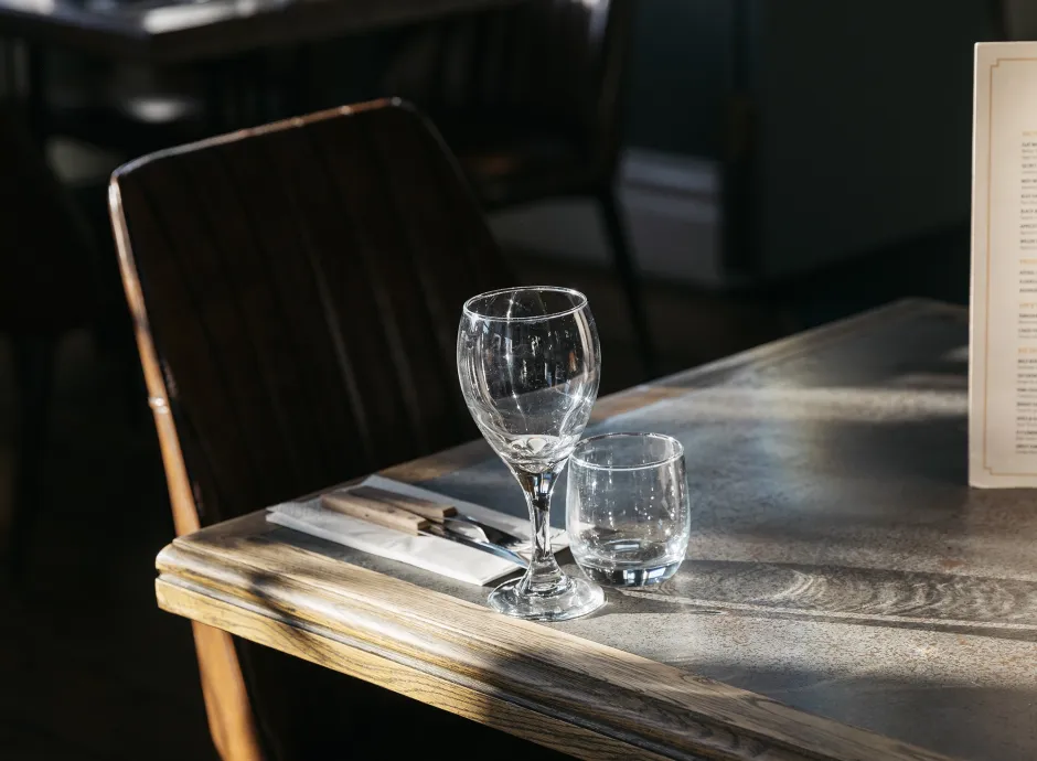 Empty glasses on a table in one of the dining areas inside The Royal Hotel Bideford