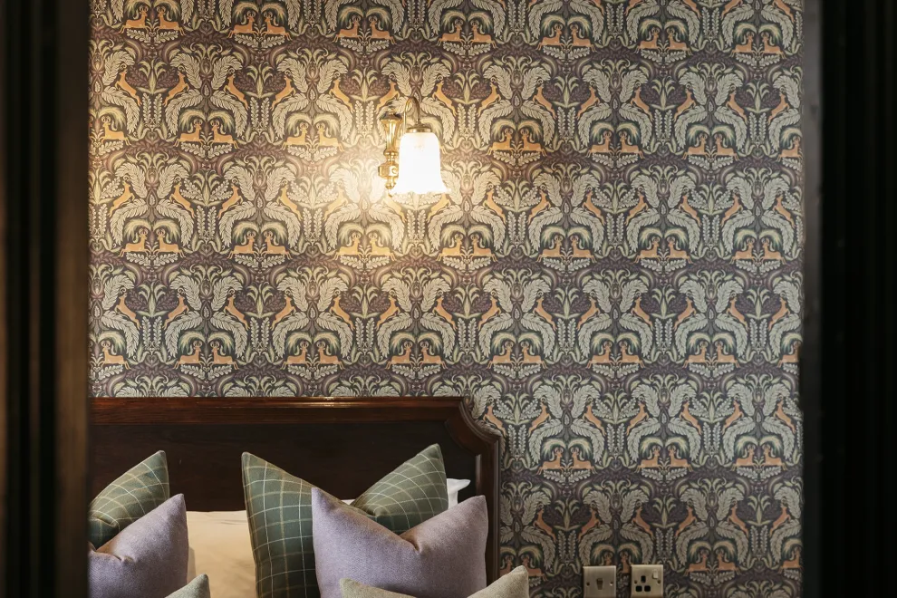 A view of pillows on a bed seen through a door frame inside The Royal Hotel Bideford