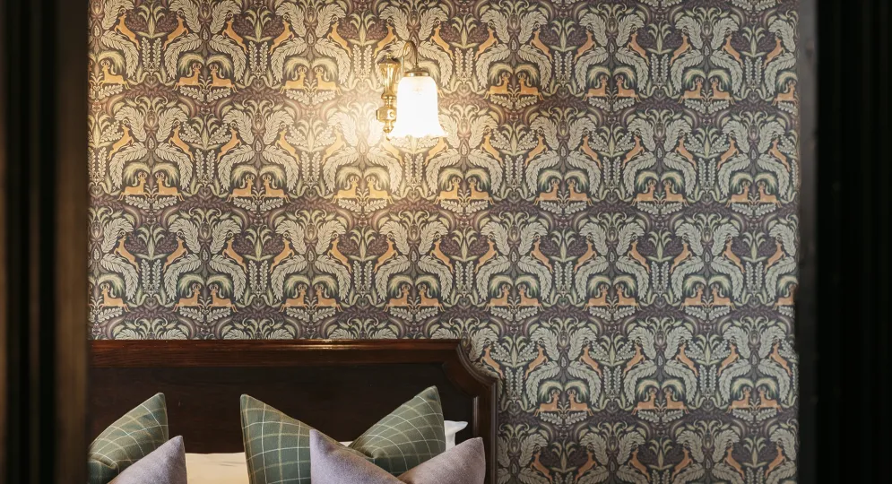 A view of pillows on a bed seen through a door frame inside The Royal Hotel Bideford