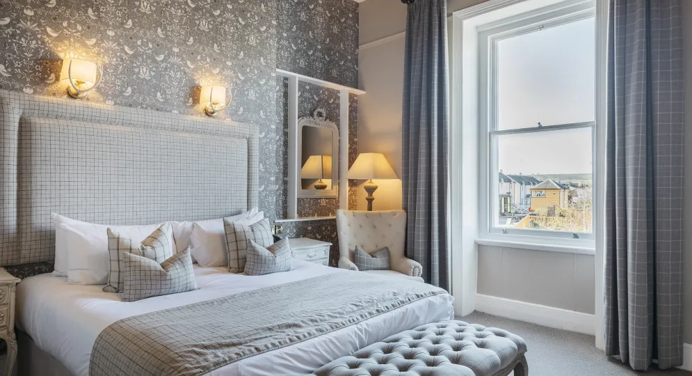 A King-size guest bedroom inside The Royal Hotel Bideford with a view over the town