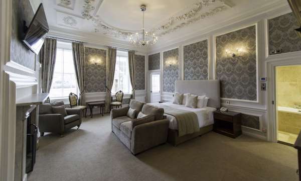 Royal Hotel Accommodation Bedroom with Lounge Area and Fireplace