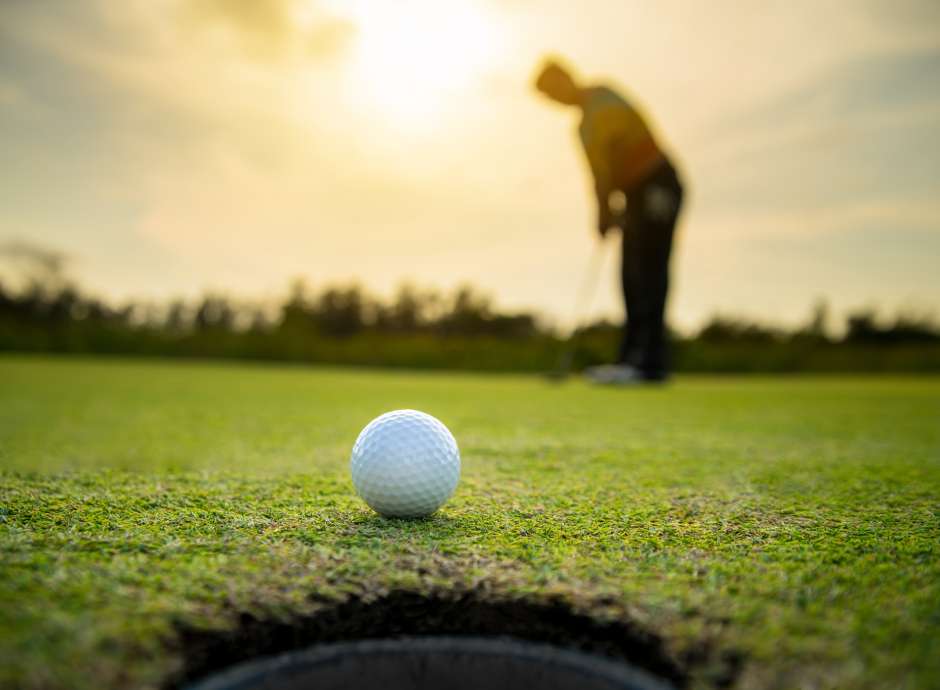golf ball and person on golf course