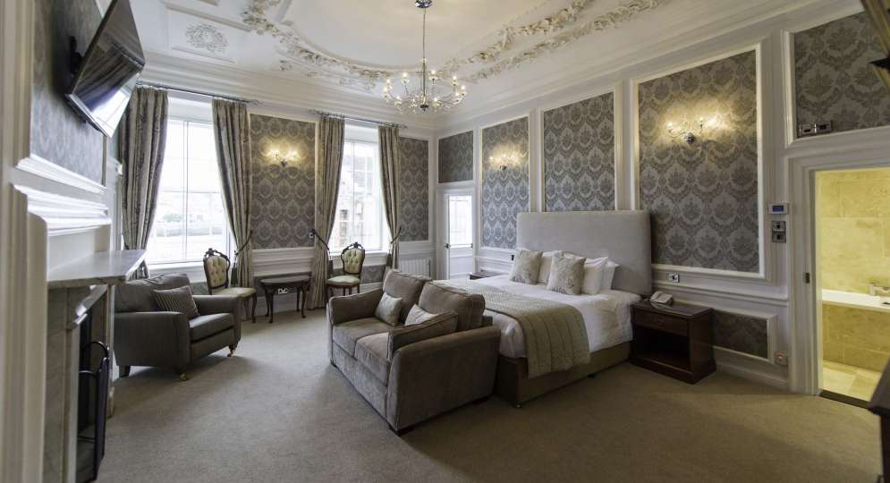 Royal Hotel Accommodation Bedroom with Lounge Area and Fireplace